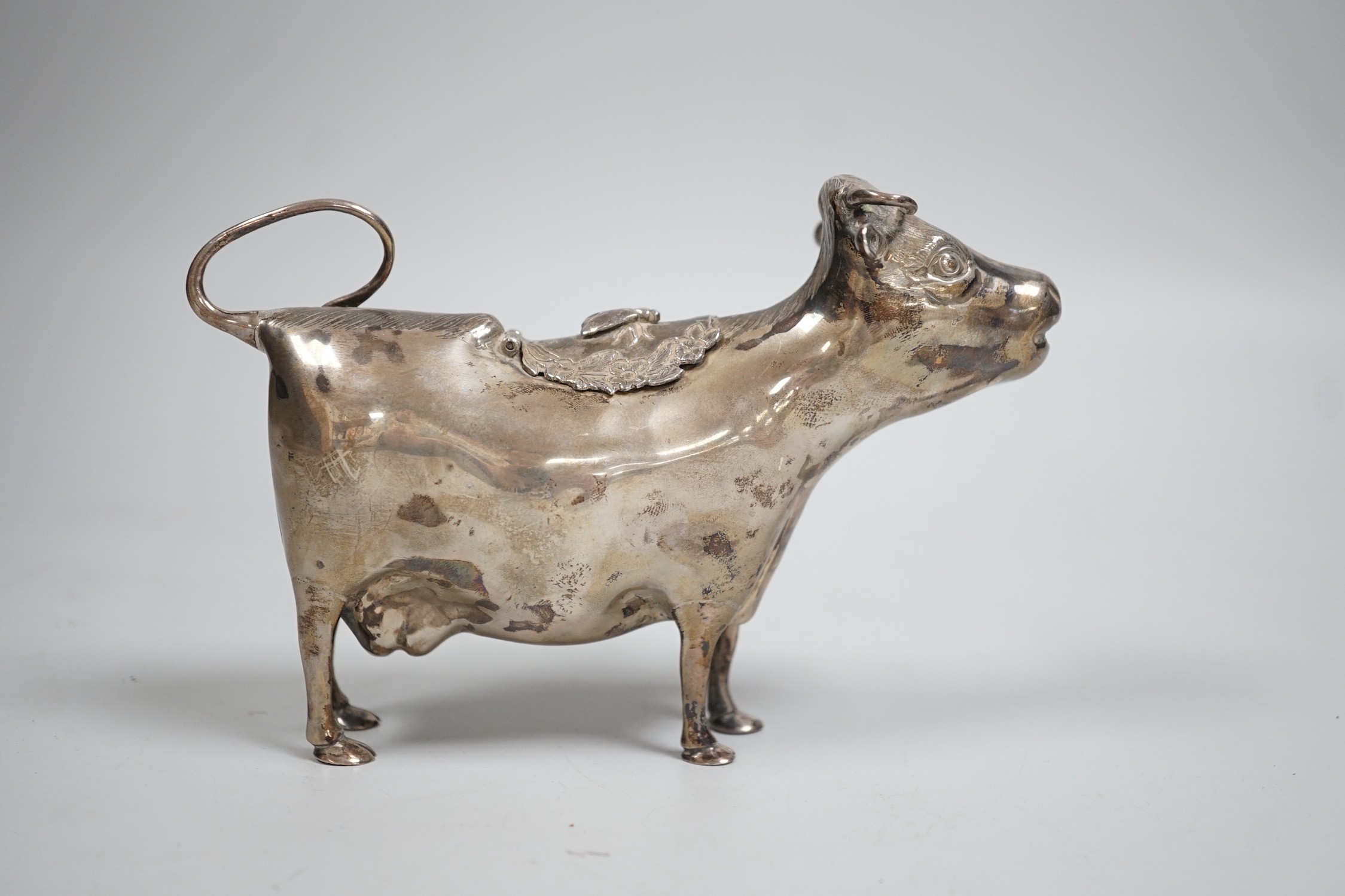 An Elizabeth II silver cow creamer, William Comyns & Sons Ltd, London, 1965, length 15cm, 152 grams.